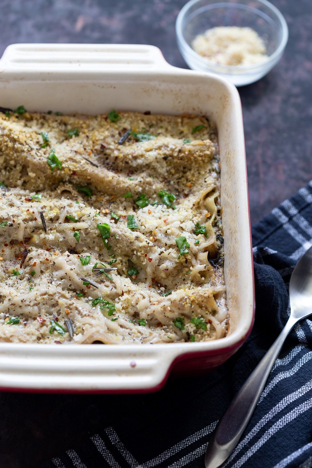Creamy Vegan Mushroom Lasagna in a white and red Lasagna Dish