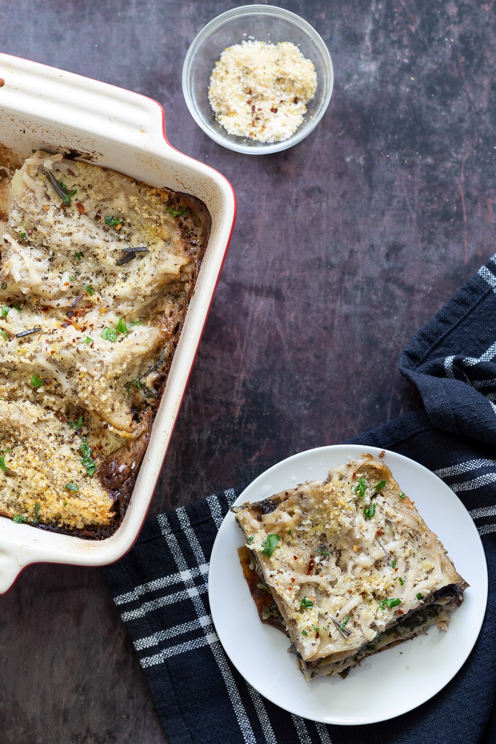 Easy Creamy Vegan Mushroom Lasagna. Marinated and baked Portobello mushrooms, creamy garlic sauce, spinach and lasagna sheets layered to make a hearty portobello lasagna. #Vegan #Recipe #veganmushroomlasagna #portobelolasagna #veganricha Can be Glutenfree Nutfree