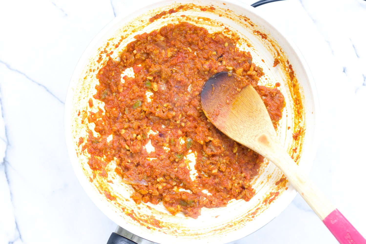 aloo matar tomato base for aloo matar peas and potatoes in a white skillet