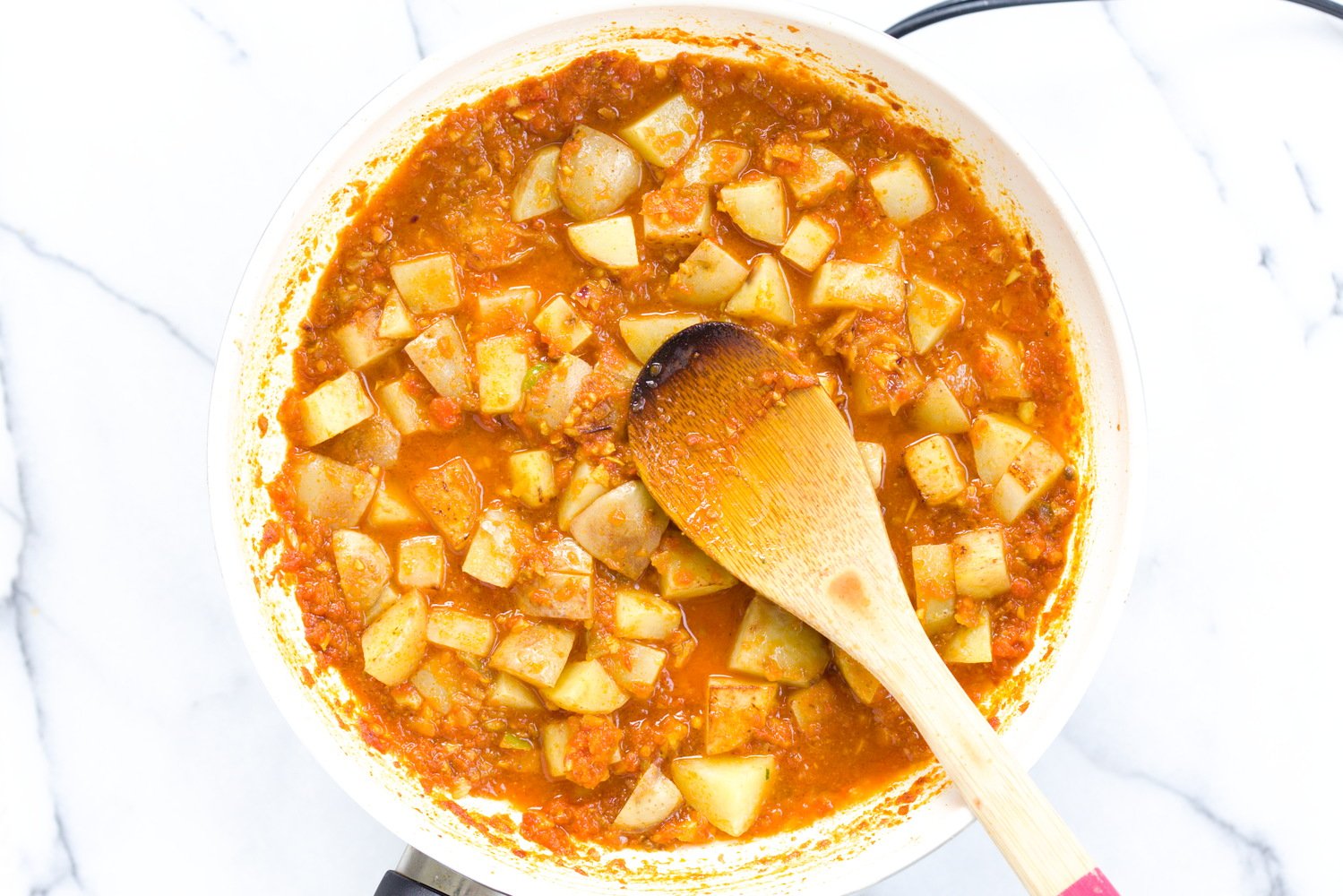 aloo matar potato cubes simmering in a rich Indian tomato gravy
