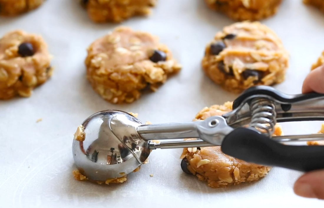 Vegan Peanut butter Oatmeal Chocolate chip Cookies dough on a parchment lined baking sheet