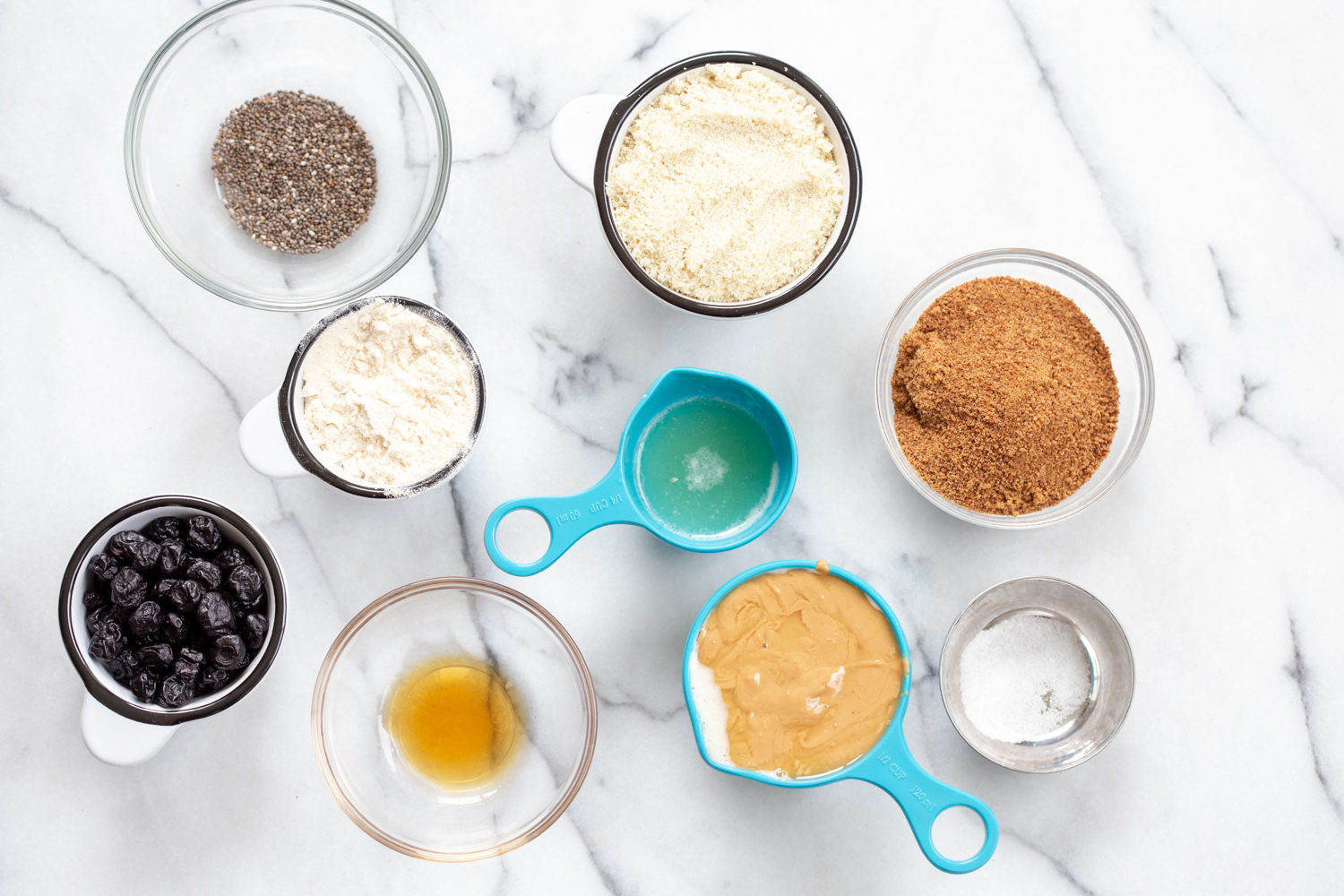 Ingredients for our Blueberry Muffin Energy Bites in bowls and measuring cups