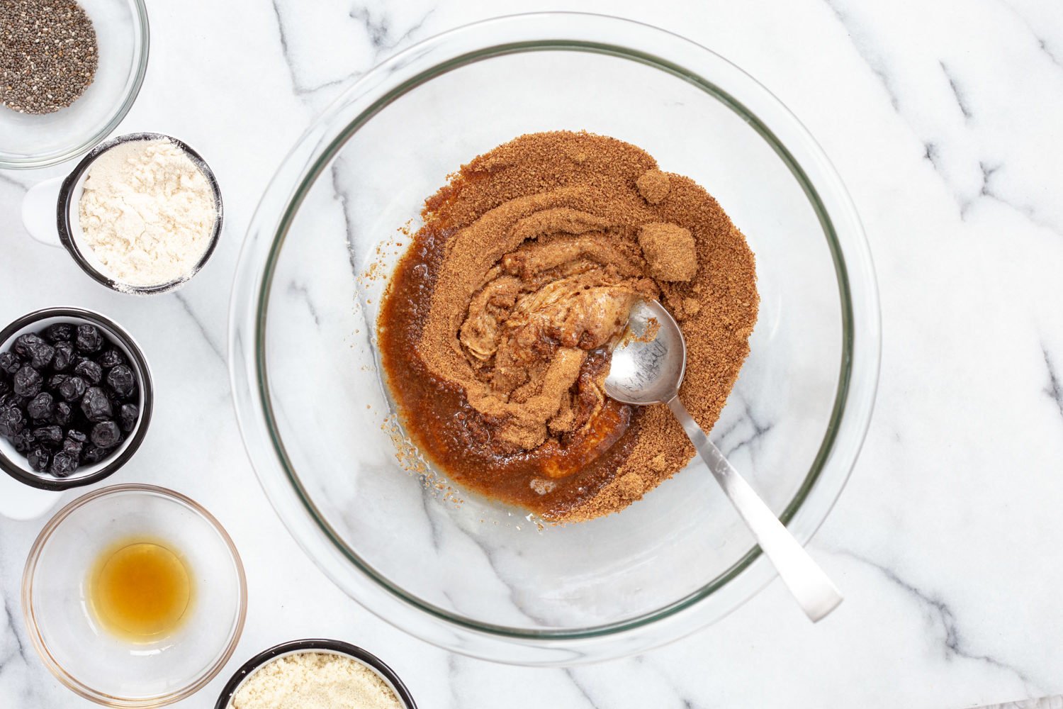 Nut butter mixed with sugar for our Blueberry Muffin Energy Bites in a white bowl