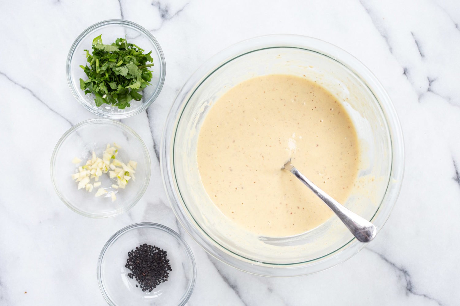 Batter for our Vegan Gluten Free Naan with garnishes in bowls
