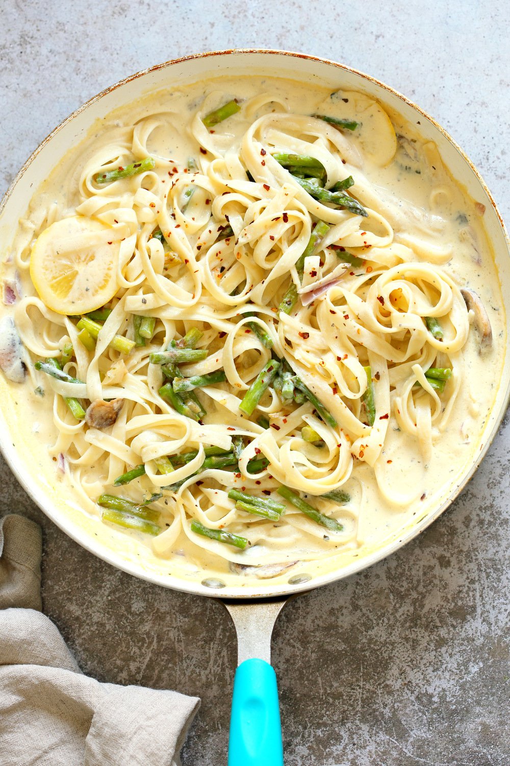 Vegan Lemon Asparagus Pasta - 30 mins! Creamy Lemon Alfredo style sauce with tofu with fettuccine and pan roasted garlic asparagus and more lemon. #Vegan #Nutfree #Recipe. Can be Glutenfree #VeganRicha #LemonAsparagusPasta 17 gm of protein