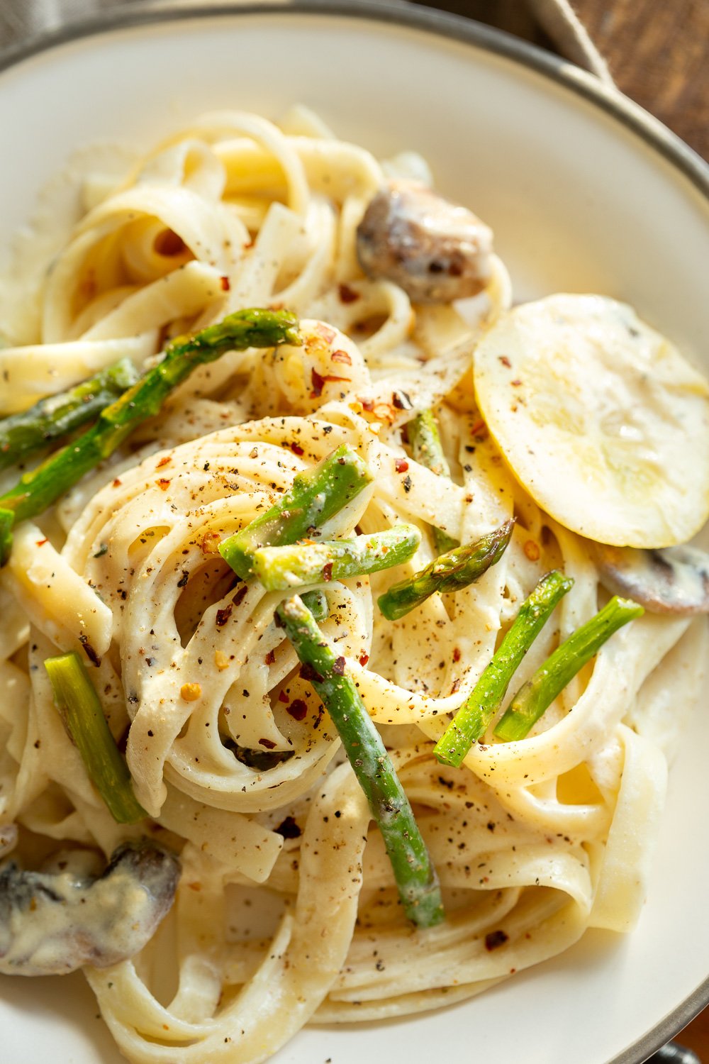 Vegan Lemon Asparagus Pasta - 30 mins! Creamy Lemon Alfredo style sauce with tofu with fettuccine and pan roasted garlic asparagus and more lemon. #Vegan #Nutfree #Recipe. Can be Glutenfree #VeganRicha #LemonAsparagusPasta 17 gm of protein