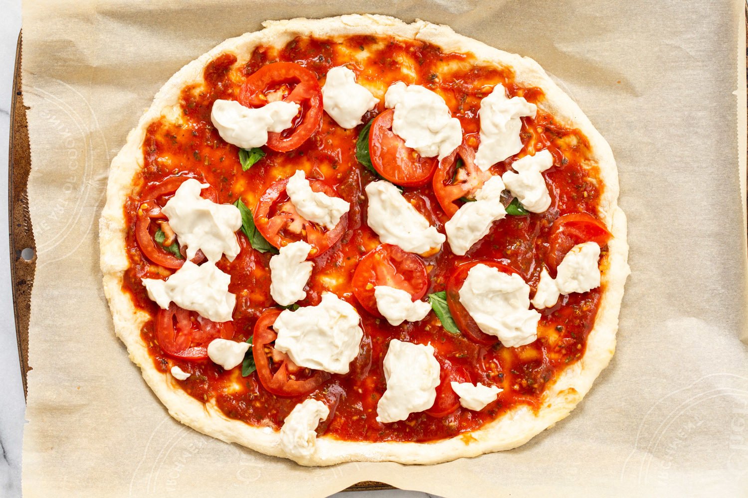 Our Vegan Margherita Pizza on parchment