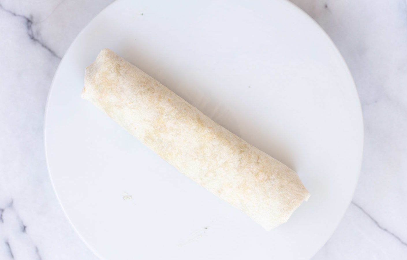 Vegan Tortilla Roll Ups assembled and Rolled up, ready to be sliced