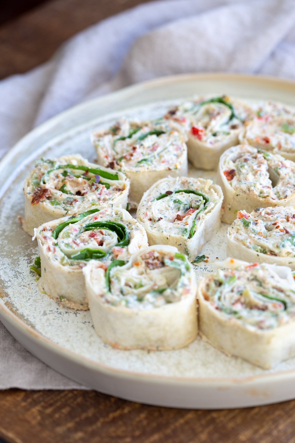Vegan Tortilla Roll Ups Recipe. Veggies and Sun-dried tomato are mixed in Tofu Herb Cream Cheese androlled to make Easy Tortilla pinwheels. Vegan Nutfree Recipe, can be gluten-free soy-free #Vegan#veganricha #tortillarollups #sundriedtotmatopinwheels