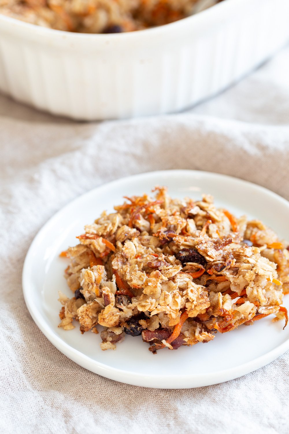 This Vegan Carrot Cake Baked Oatmeal has roasted carrots,, spices, nuts, dates and Oats! Crisp on the outside and spiced, delicious carrot cake like inside. #refinedoilfree #Vegan #Soyfree #Recipe #VeganRicha #carrotcakeoatmeal #carrotcakebakedoatmeal Easily nutfree, #glutenfree
