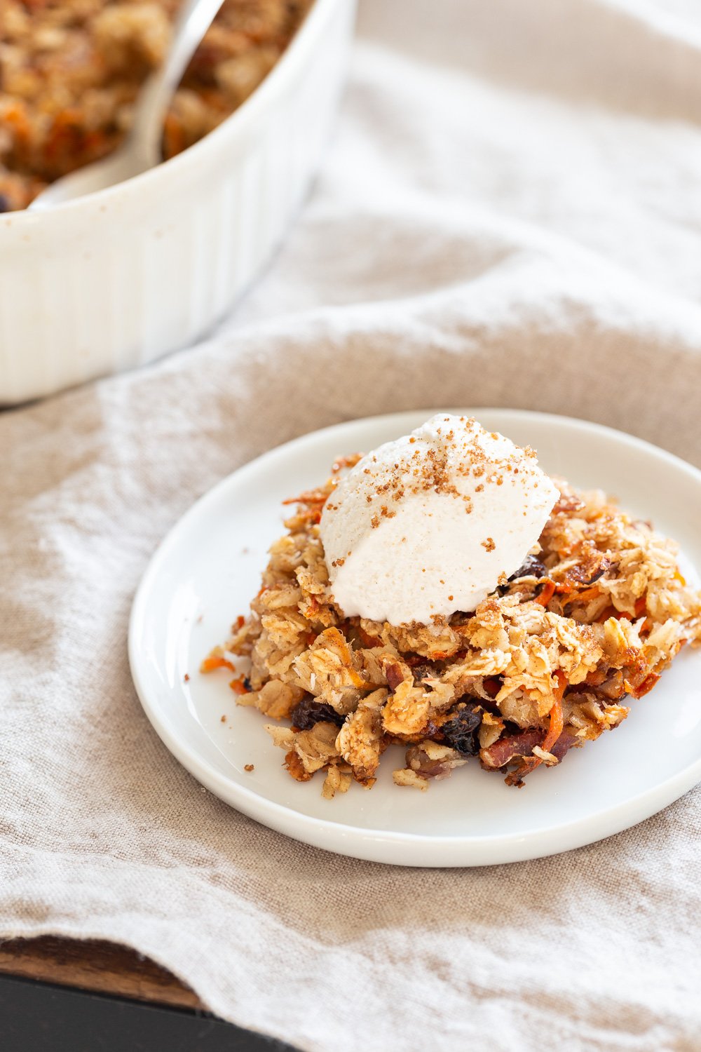 This Vegan Carrot Cake Baked Oatmeal has roasted carrots,, spices, nuts, dates and Oats! Crisp on the outside and spiced, delicious carrot cake like inside.  #Vegan #Soyfree #Recipe #Oilfree #VeganRicha #carrotcakeoatmeal #carrotcakebakedoatmeal Easily nutfree, #glutenfree