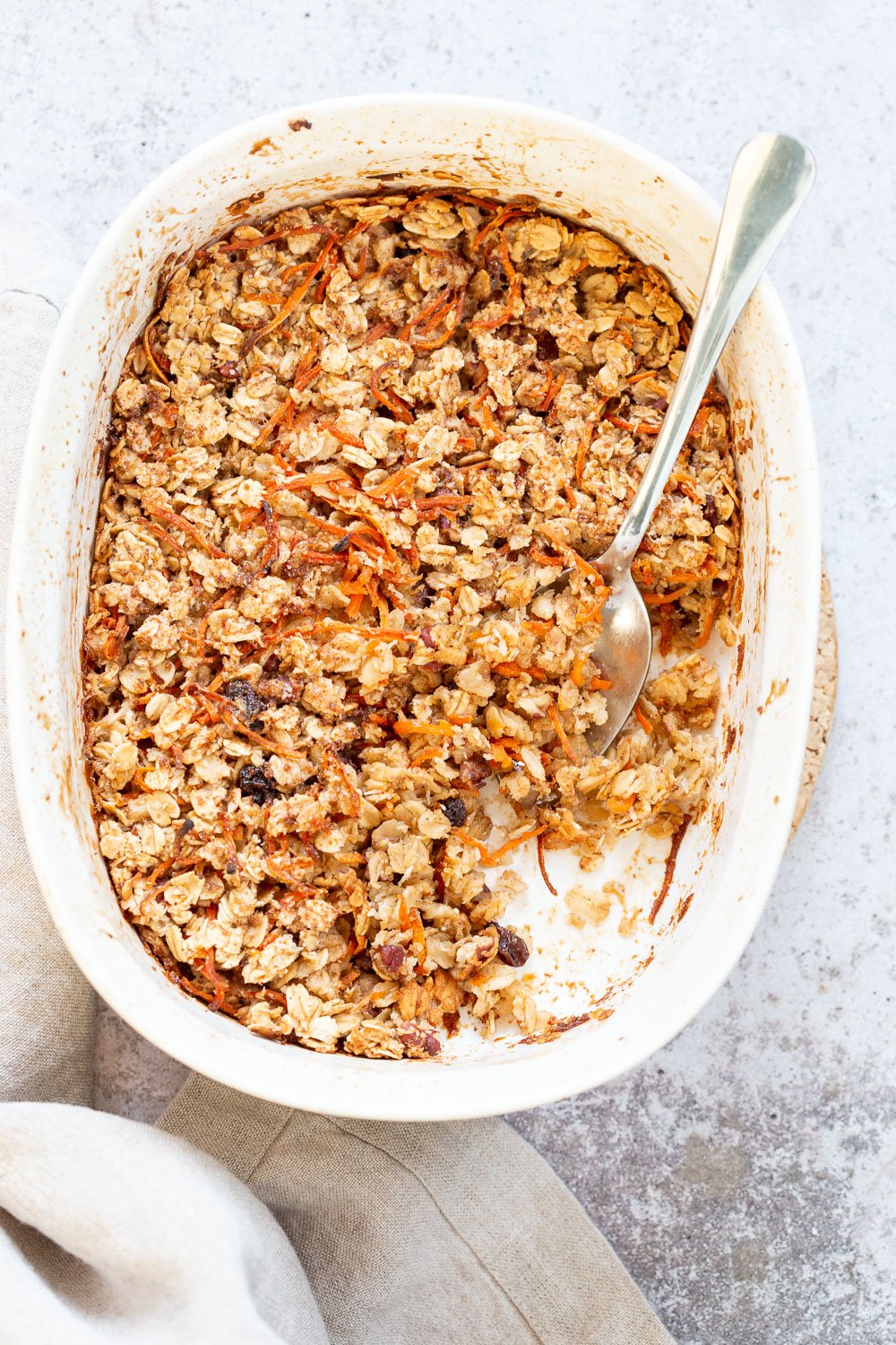 This Vegan Carrot Cake Baked Oatmeal has roasted carrots,, spices, nuts, dates and Oats! Crisp on the outside and spiced, delicious carrot cake like inside.  #Vegan #Soyfree #Recipe #VeganRicha #carrotcakeoatmeal #carrotcakebakedoatmeal Easily nutfree, #glutenfree