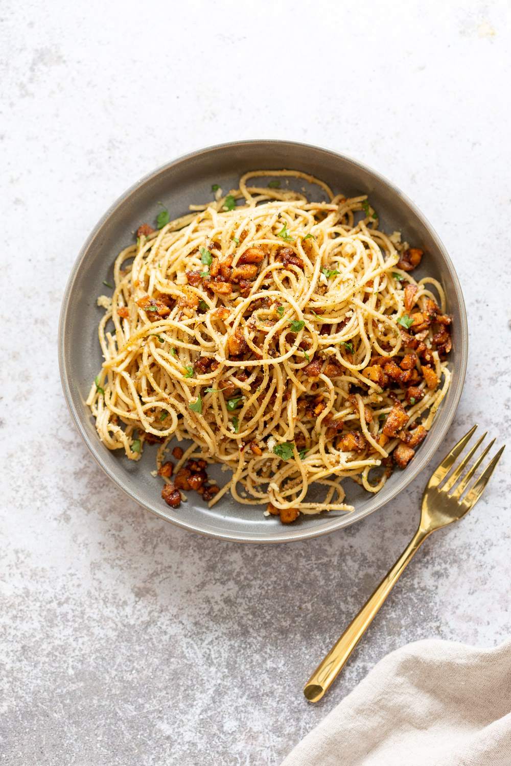 Our Vegan Cacio e Pepe with Smoky Chickpea Tofu Bits in grey Bowl