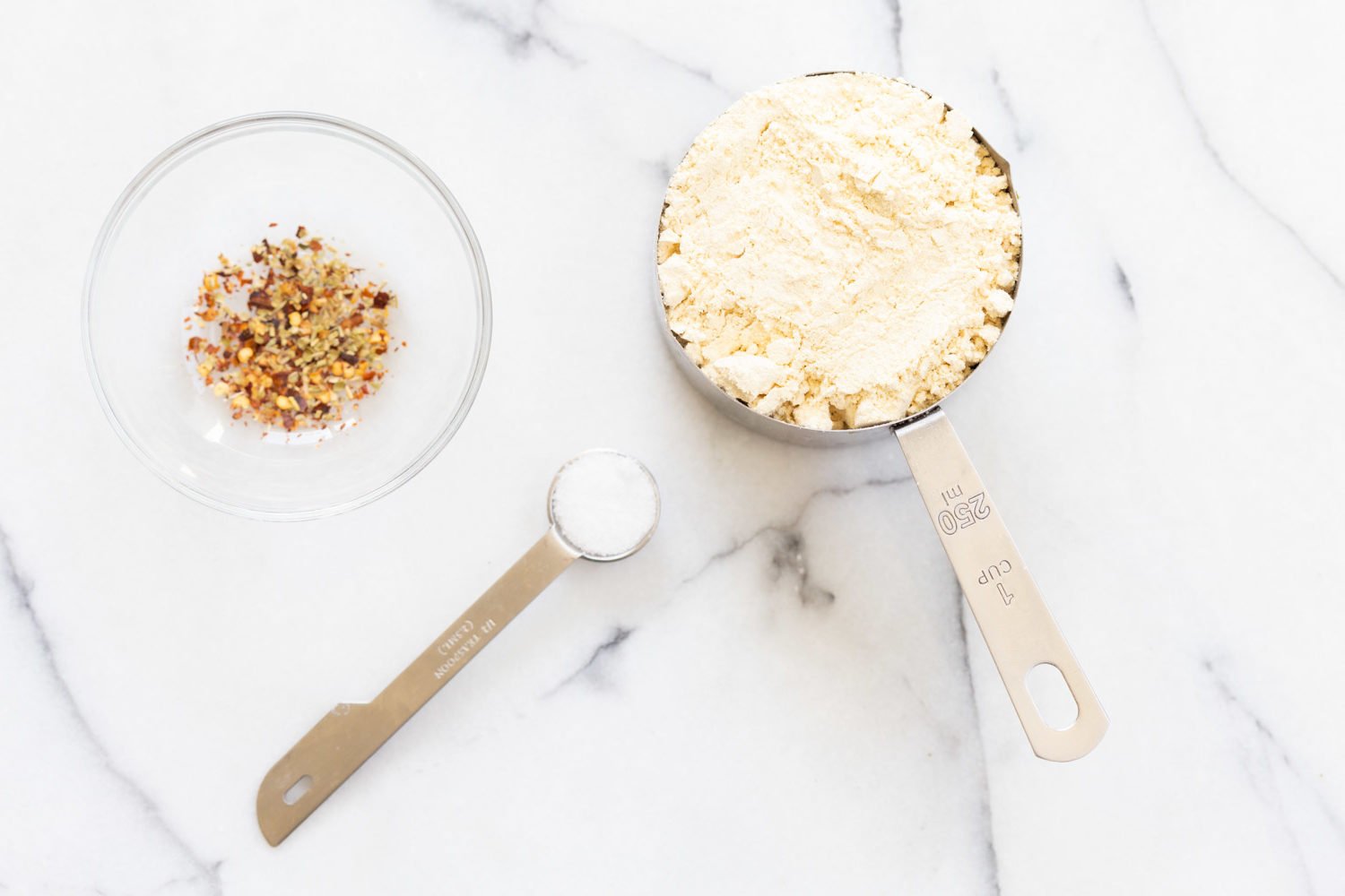 Ingredients for Vegan Socca in measuring cups and bowls