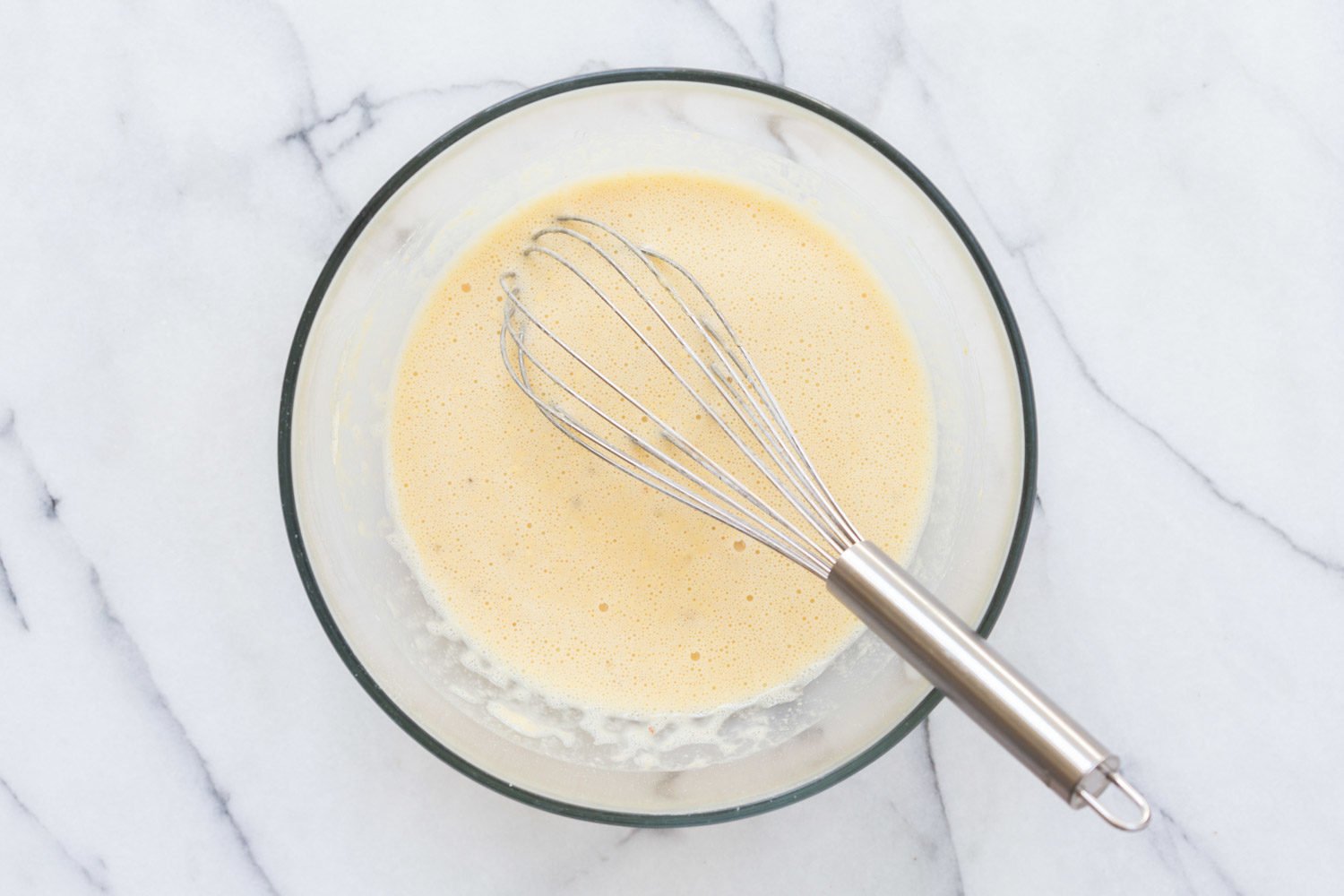 Chickpea Flour Batter in a glass bowl for our Vegan Socca
