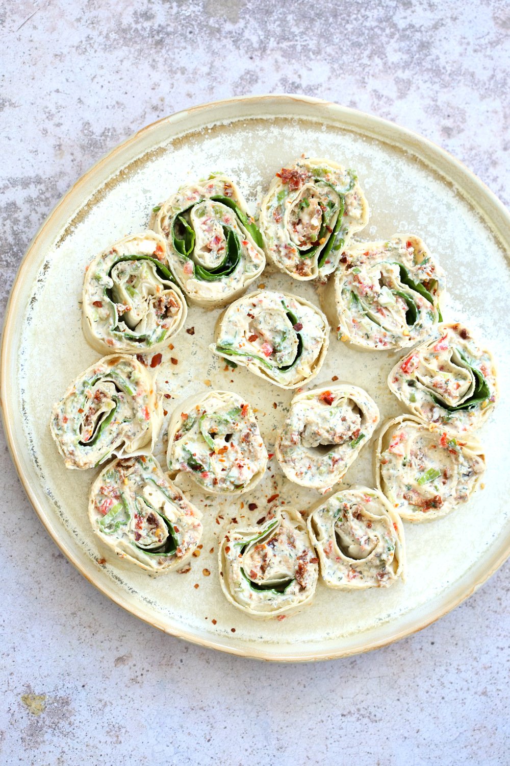 Vegan Tortilla Roll Ups Recipe. Veggies and Sun-dried tomato are mixed in Tofu Herb Cream Cheese androlled to make Easy Tortilla pinwheels. Vegan Nutfree Recipe, can be gluten-free soy-free #Vegan#veganricha #tortillarollups #sundriedtotmatopinwheels