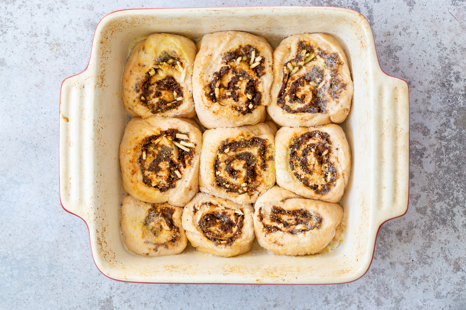 Vegan Pizza Rolls ready to bake in a ceramic baking dish