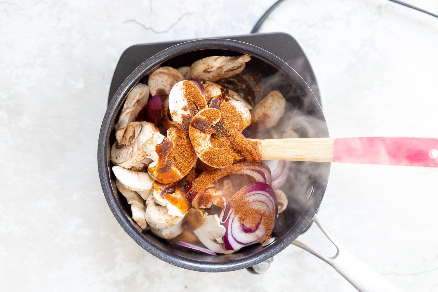 Mushrooms and shawarma spice in a saucepan for out Vegan Mushroom Gyro.