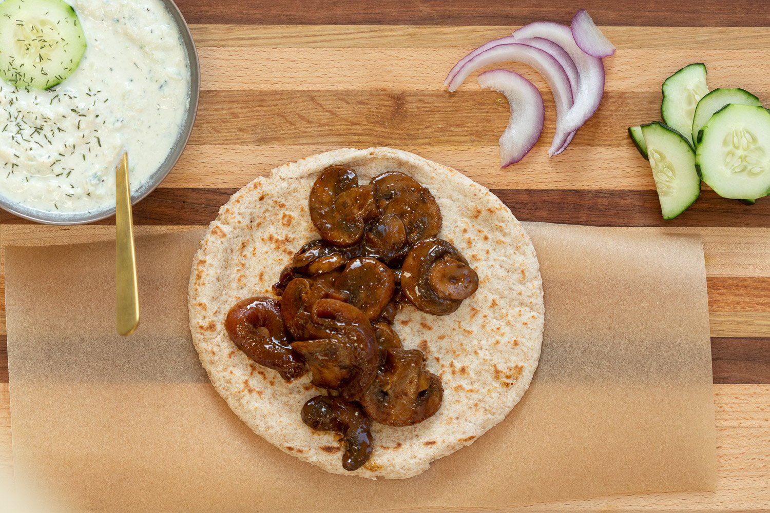 Assembly of Vegan Gyros with Mushrooms and tzatziki on Wood Board