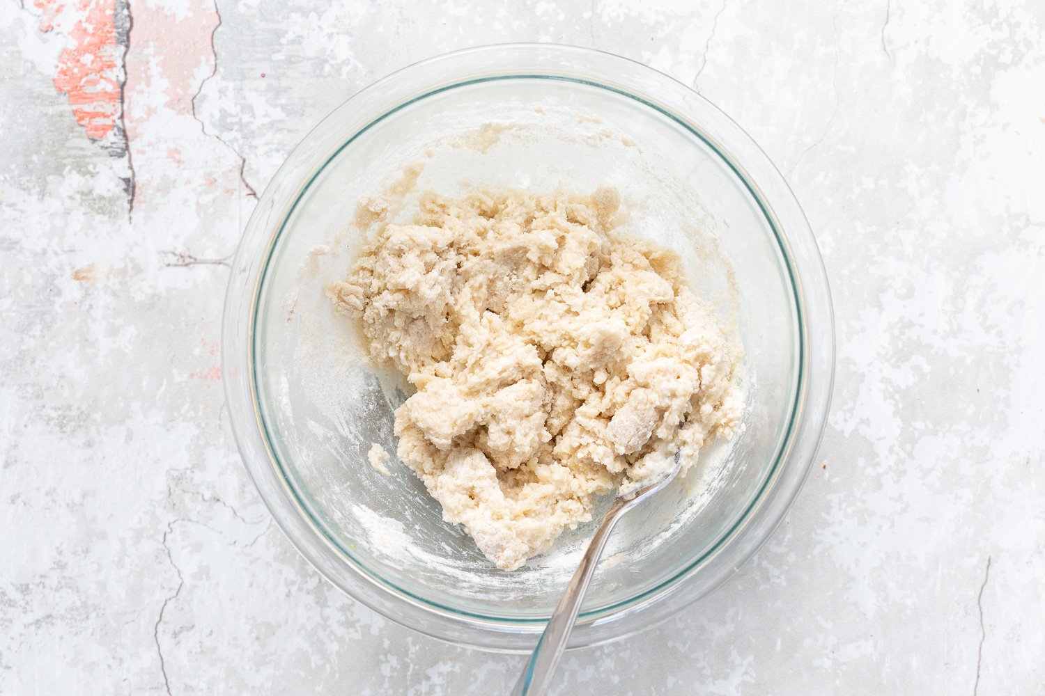 Dough in a glass bowl for the biscuit topping of our Vegan Blueberry Cobbler
