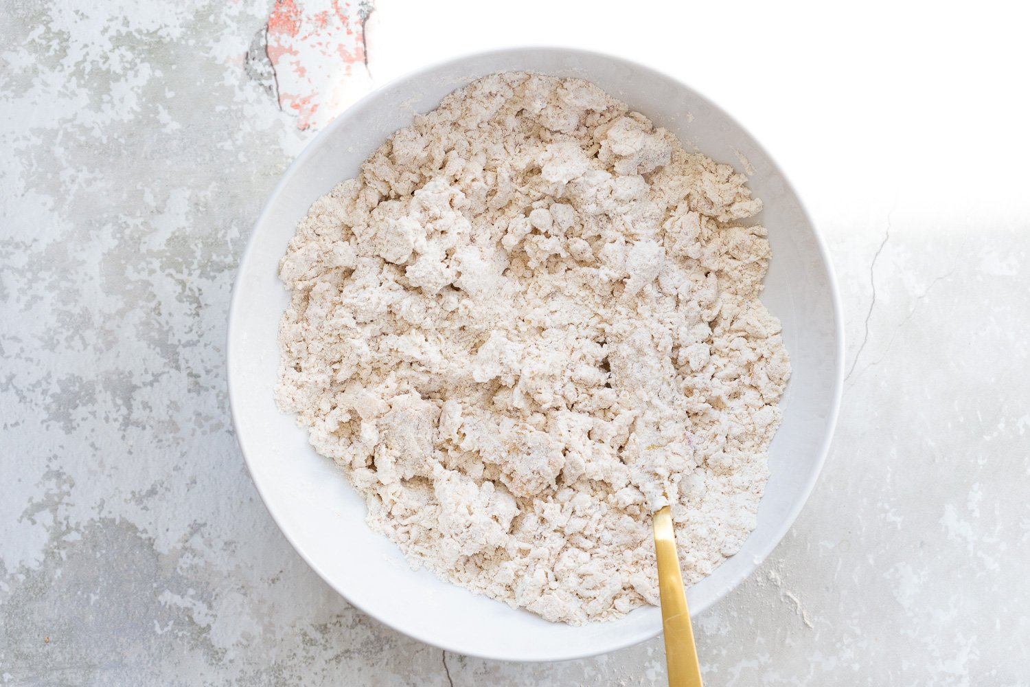 Coconut cream mixed with the dry ingredients for our Vegan Churro Scones in a white bowl