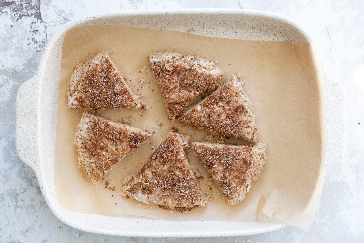 Sliced Dough for our Vegan Churro Scones in a parchment lined baking sheet.