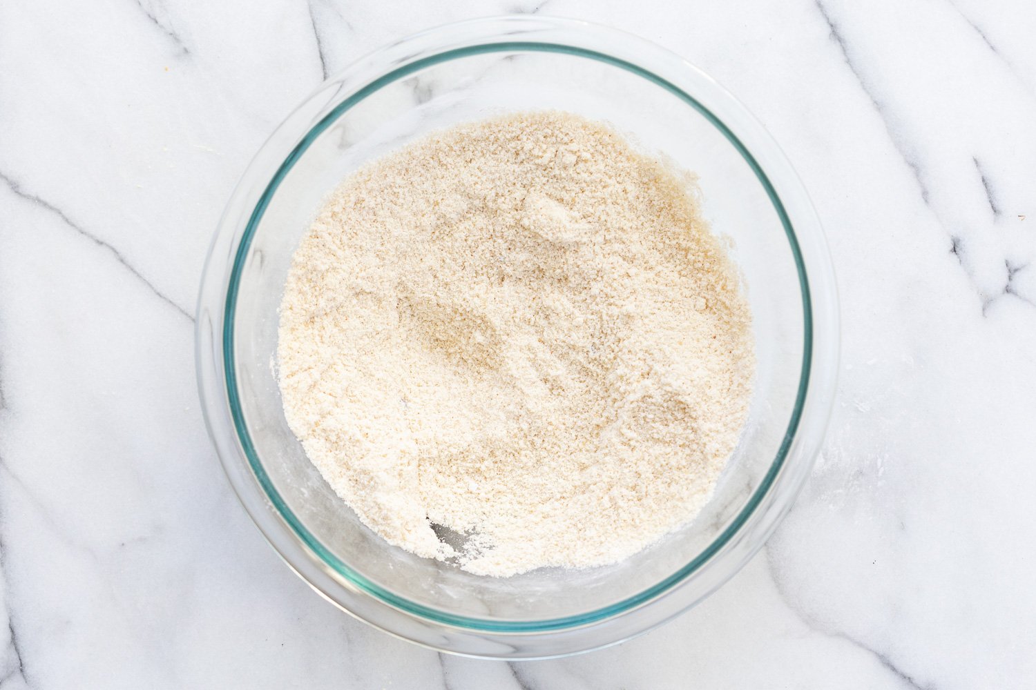 Dry ingredients for our Vegan Gluten free Cinnamon Rolls in a glass bowl