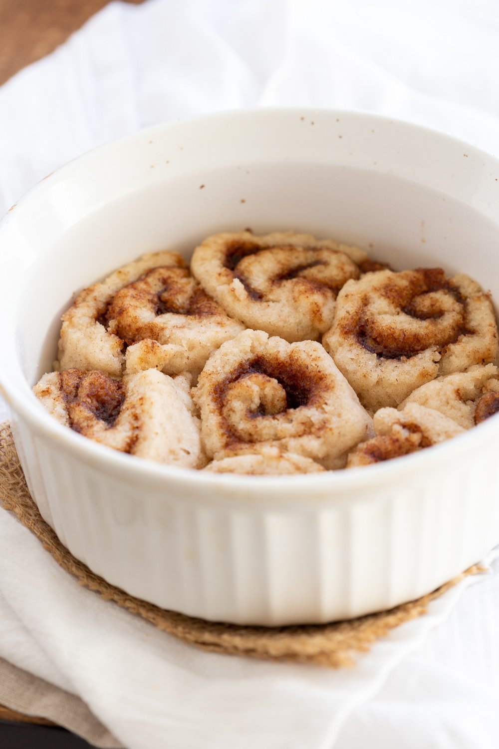 Our Vegan Gluten free Cinnamon rolls in a stoneware dish