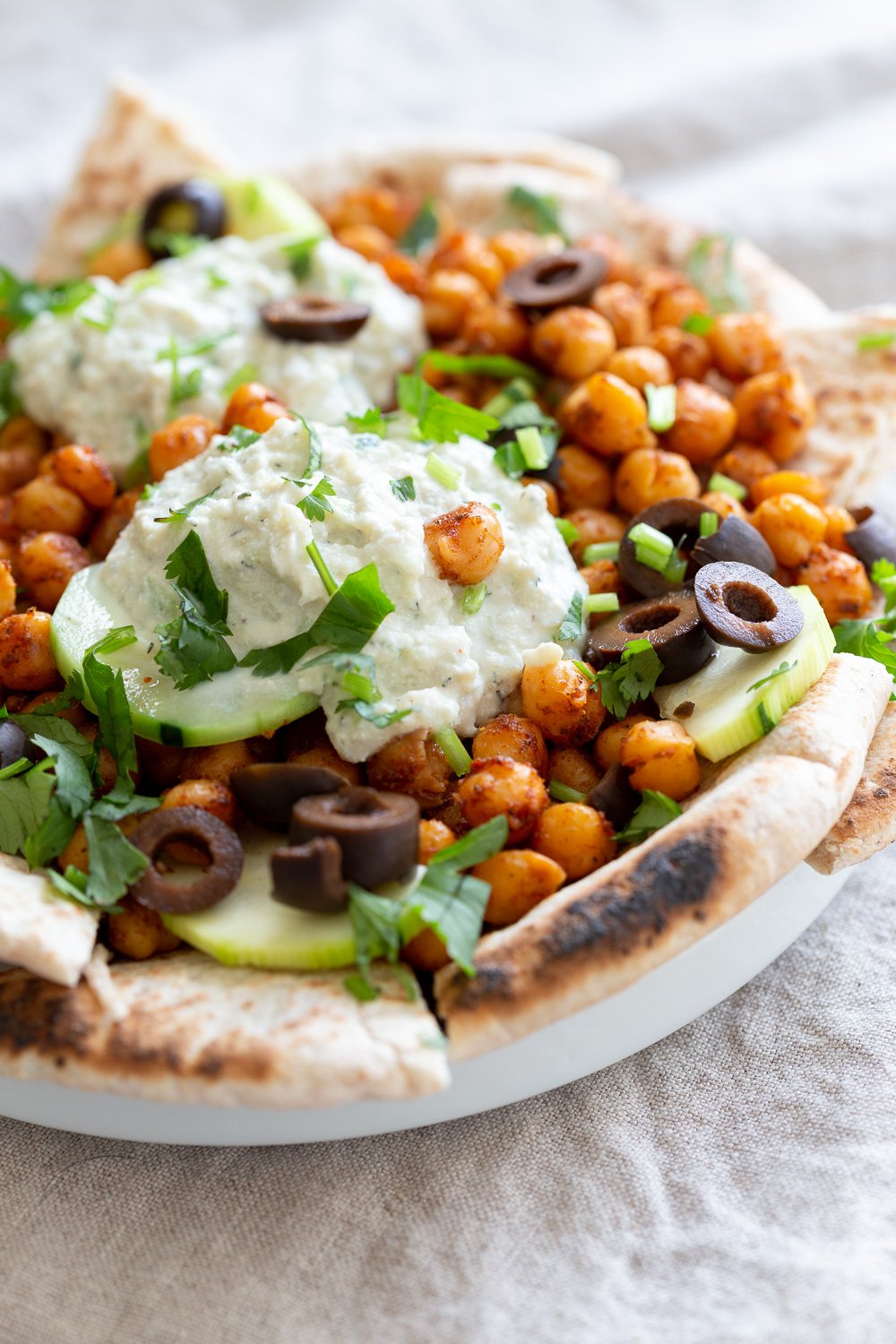 Vegan Mediterranean Nachos in white plate