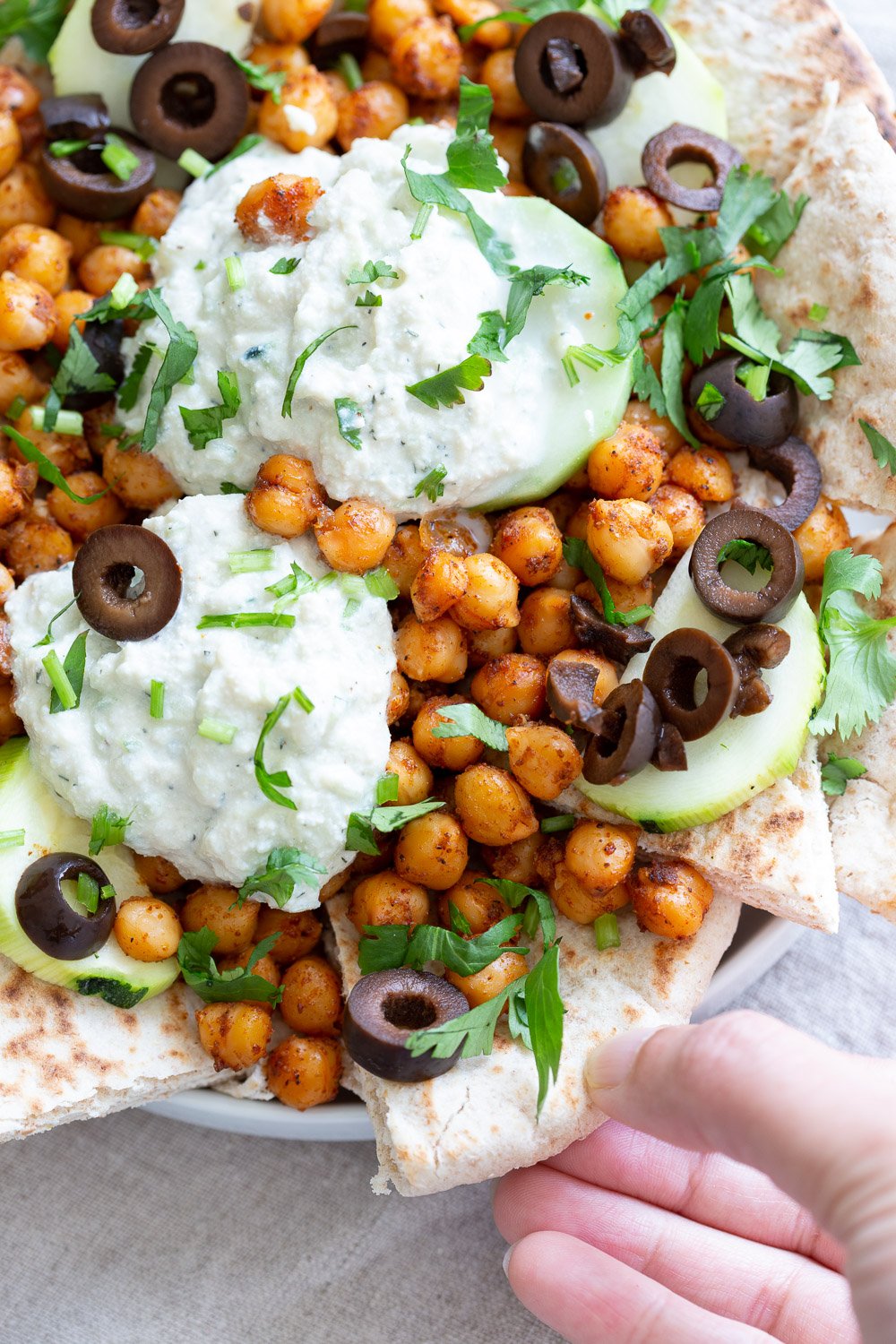 Vegan Mediterranean Nachos with Shawarma Chickpeas, Tzatziki, Olives, Cucumber, warm toasted Pita bread. Great Appetizer for parties or potluck. #Vegan #nutfree #recipe #Veganricha #Mediterraneannachos
