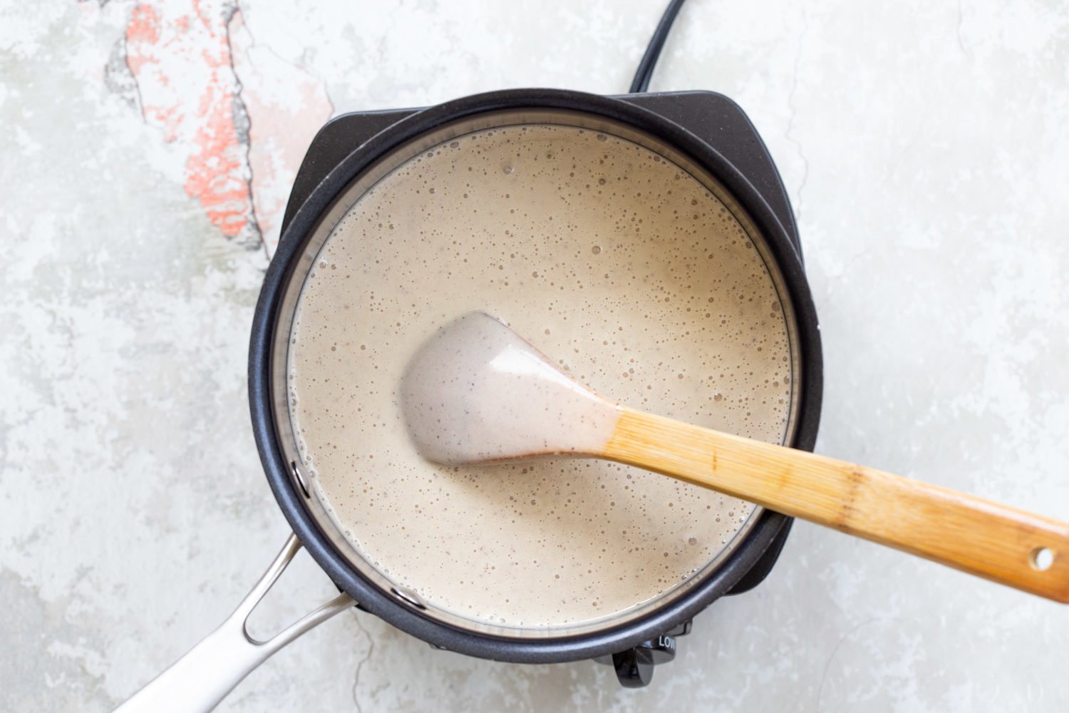 Vegan Coconut Vanilla Ice cream for our Vegan Cookie Dough Ice Cream Sandwiches in a saucepan 