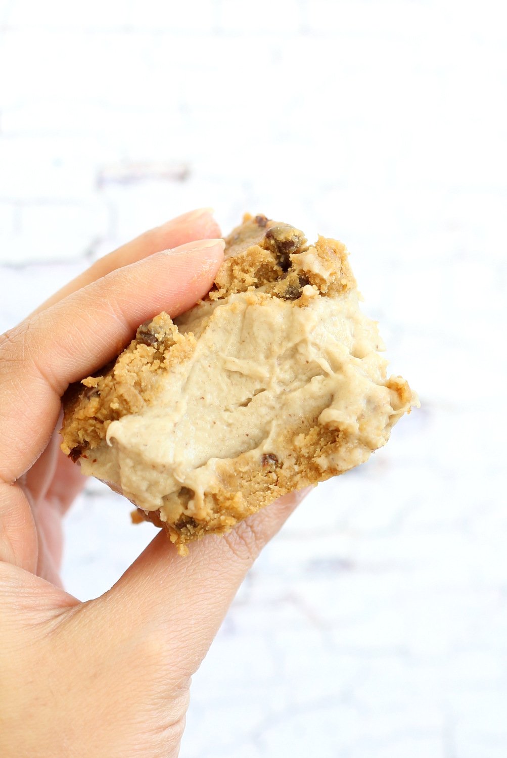 One of our Vegan Cookie Dough Ice Cream Sandwiches held in a hand