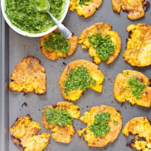 Crispy Vegan Smashed Potatoes with Chimichurri. These Smashed potatoes are baked to a crisp and served with fresh homemade parsley chimichurri. #VeganRicha #VeganSmashedPotatoes #Vegan #Glutenfree #Nutfree #Soyfree #Recipe
