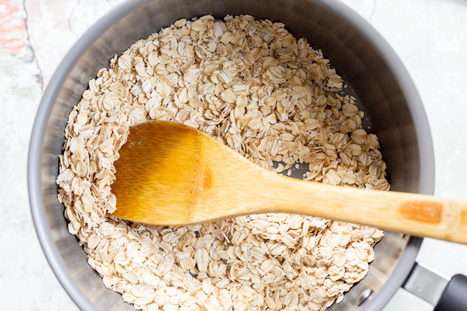 Oats toasted for our Vegan sunbutter Granola Bars in a saucepan