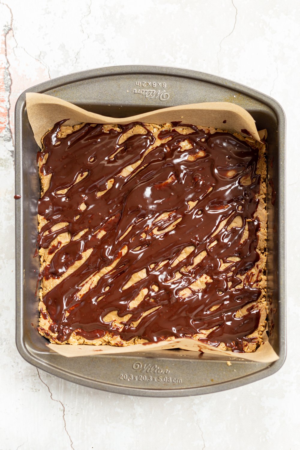 Chocolate drizzle on our vegan sunbutter granola bars in a grey dish