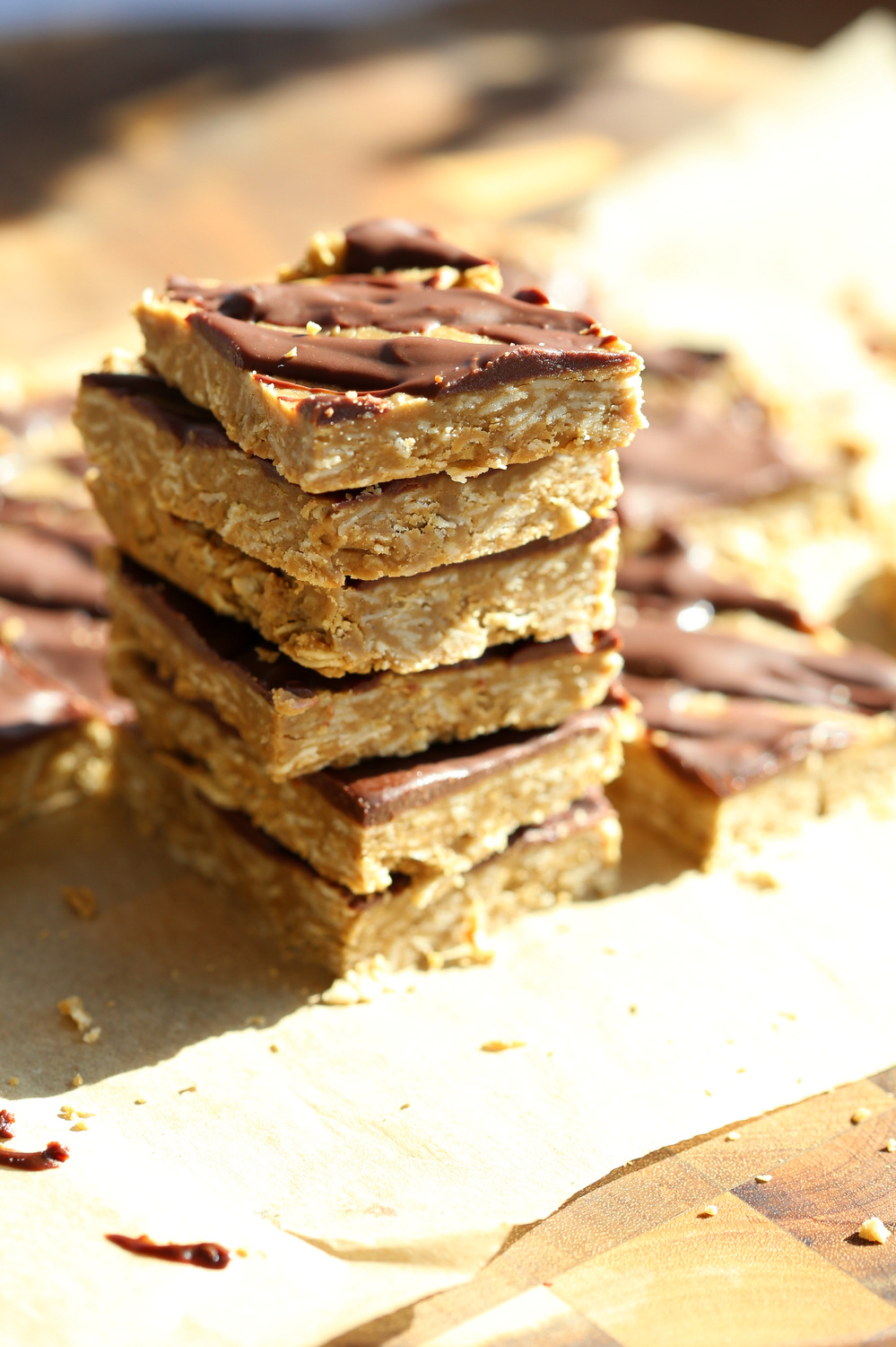Our Vegan Sunbutter Granola Bars stacked on top of each other on a wood board