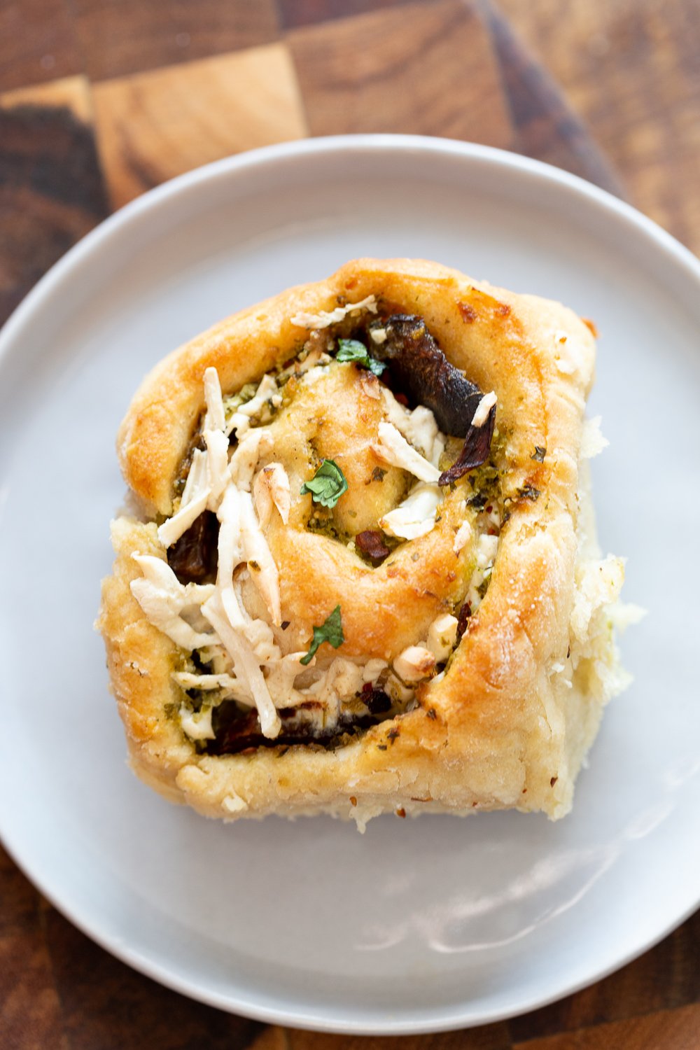 pizza rolls recipe overhead shot of a vegan Pesto Pizza roll topped with vegan shredded mozzarella cheese