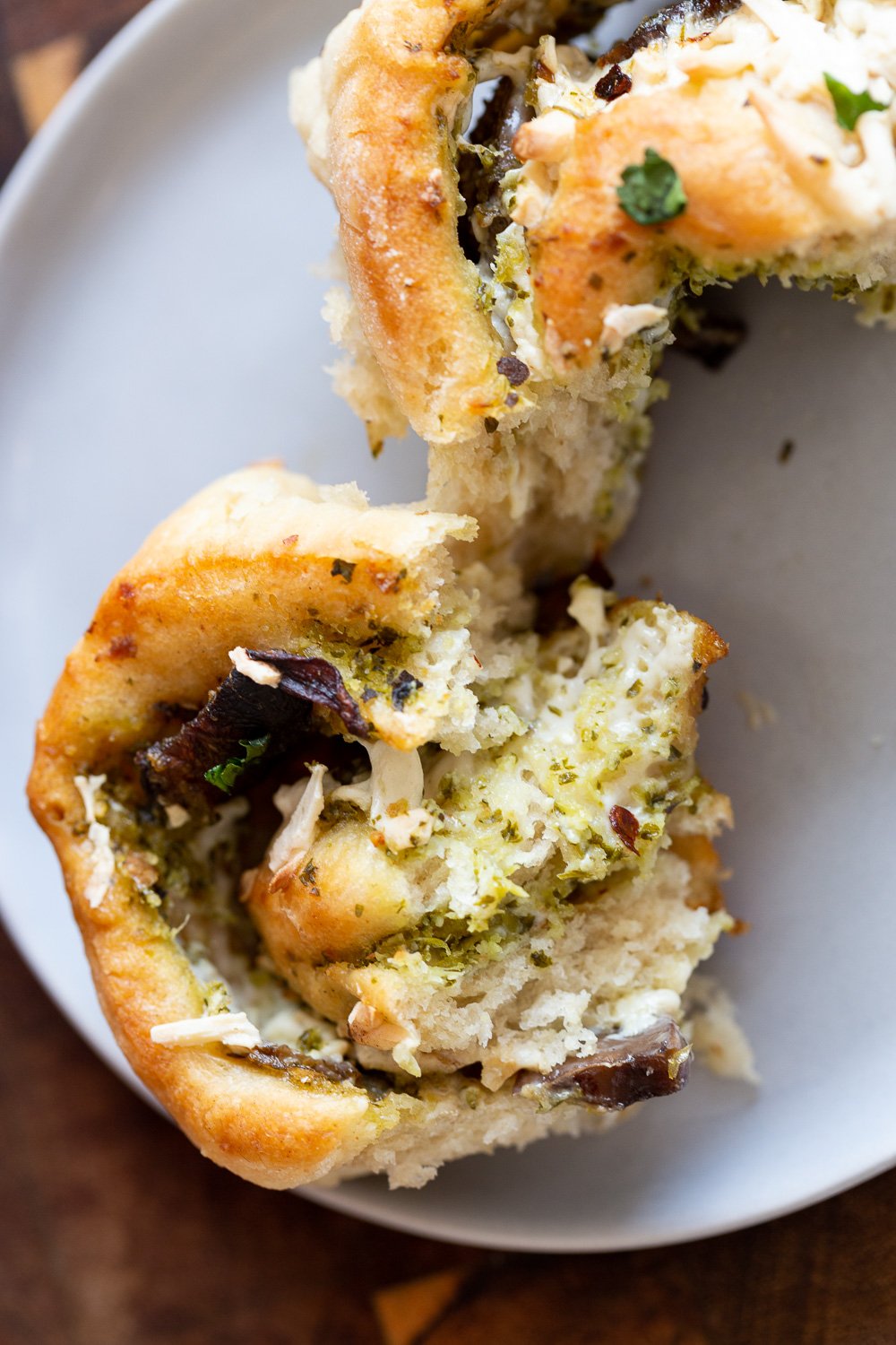 pizza rolls recipe a fluffy and soft homemade Vegan Pesto Pizza roll being torn into two pieces
