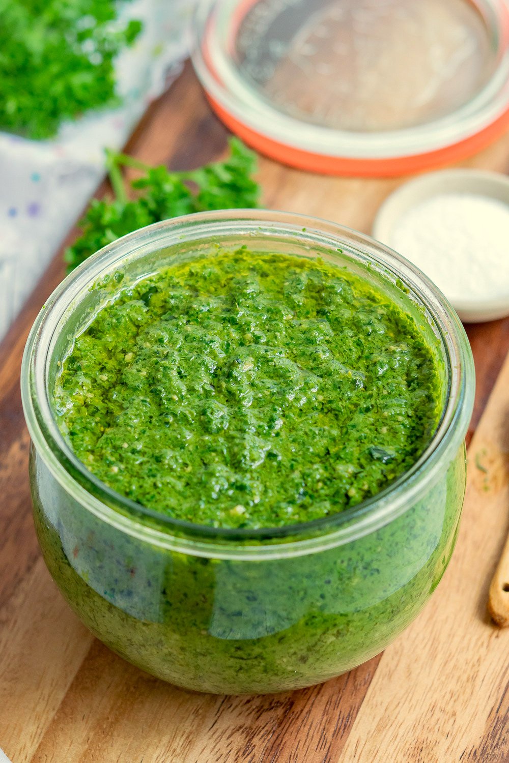Cheesy Vegan Pesto in a glass jar kept on wood board