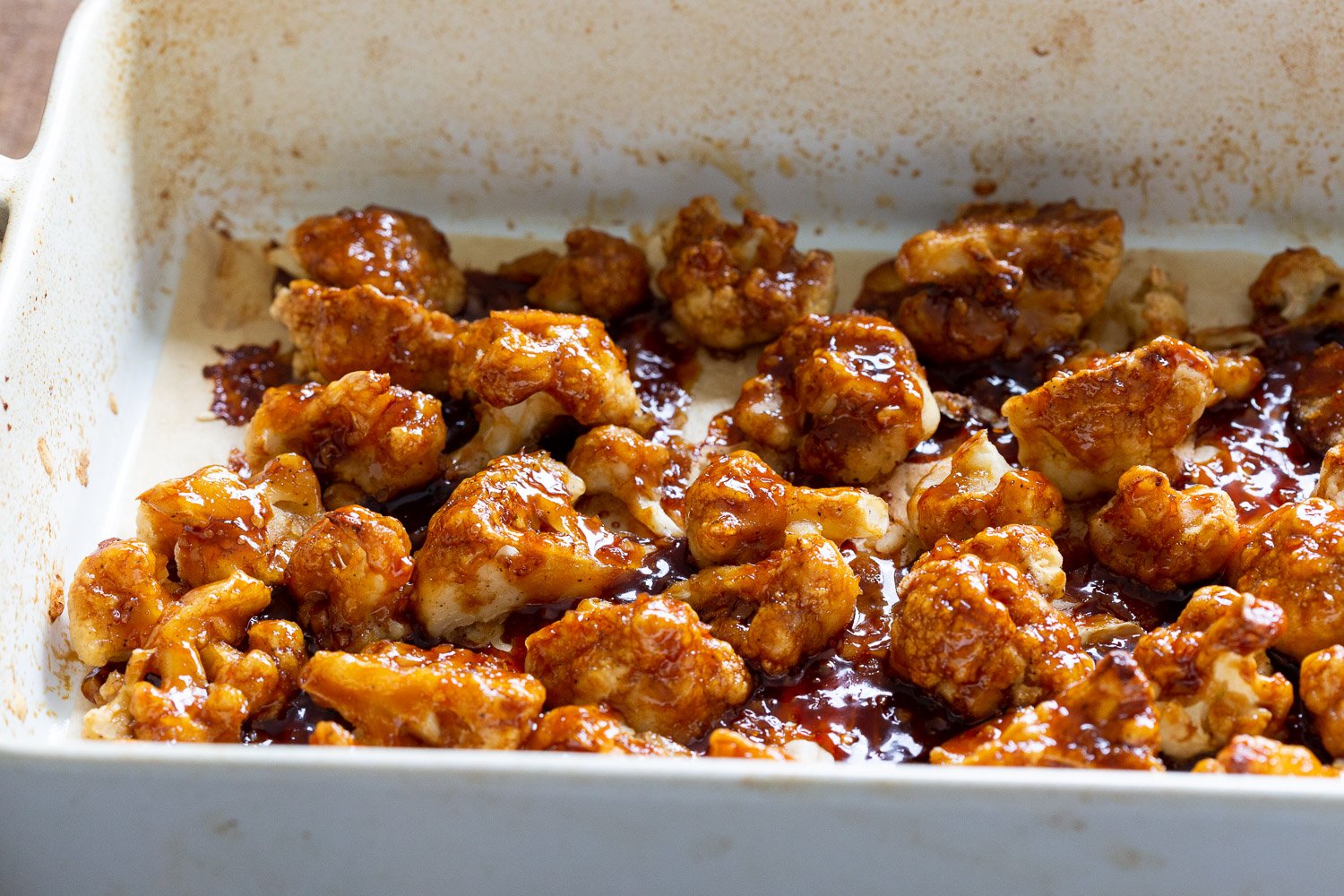 Vegan Sticky Sesame Cauliflower glazed in a baking dish