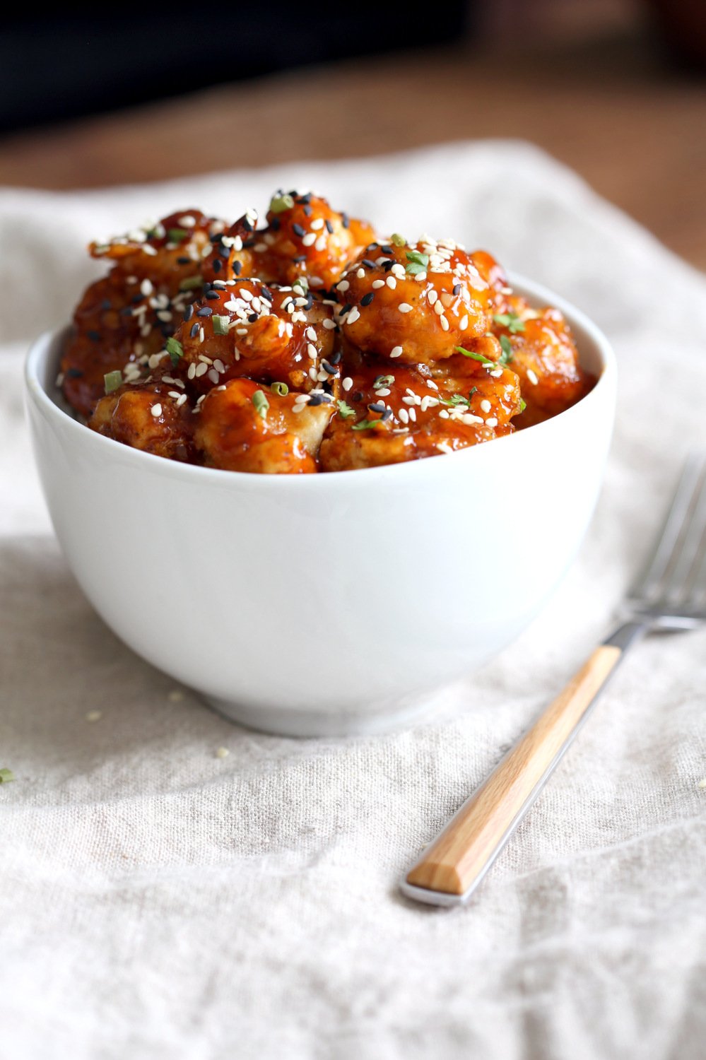 Vegan Sticky Sesame Cauliflower over rice in a white bowl