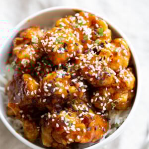Vegan Sticky Sesame Cauliflower over rice in a white bowl