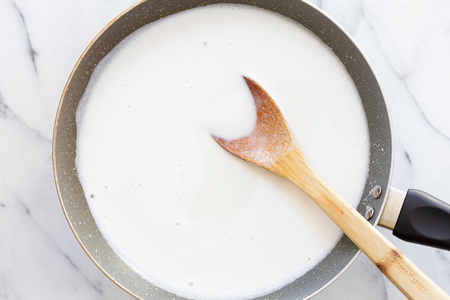 Cashew Mozzarella for our Vegan Mushroom Quesadilla, in a grey pan