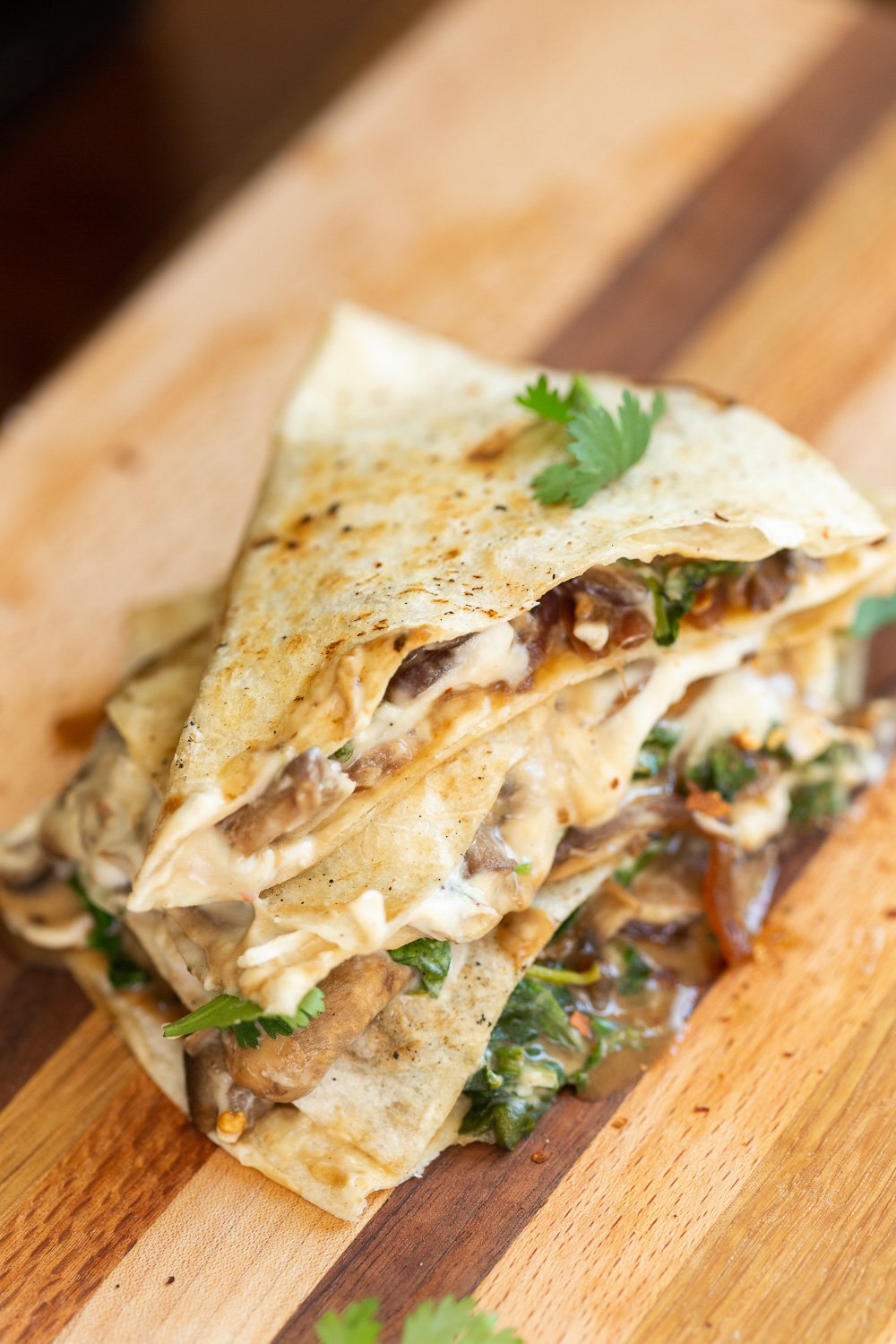 Grilled and sliced Vegan Mushroom Quesadilla on Wood board