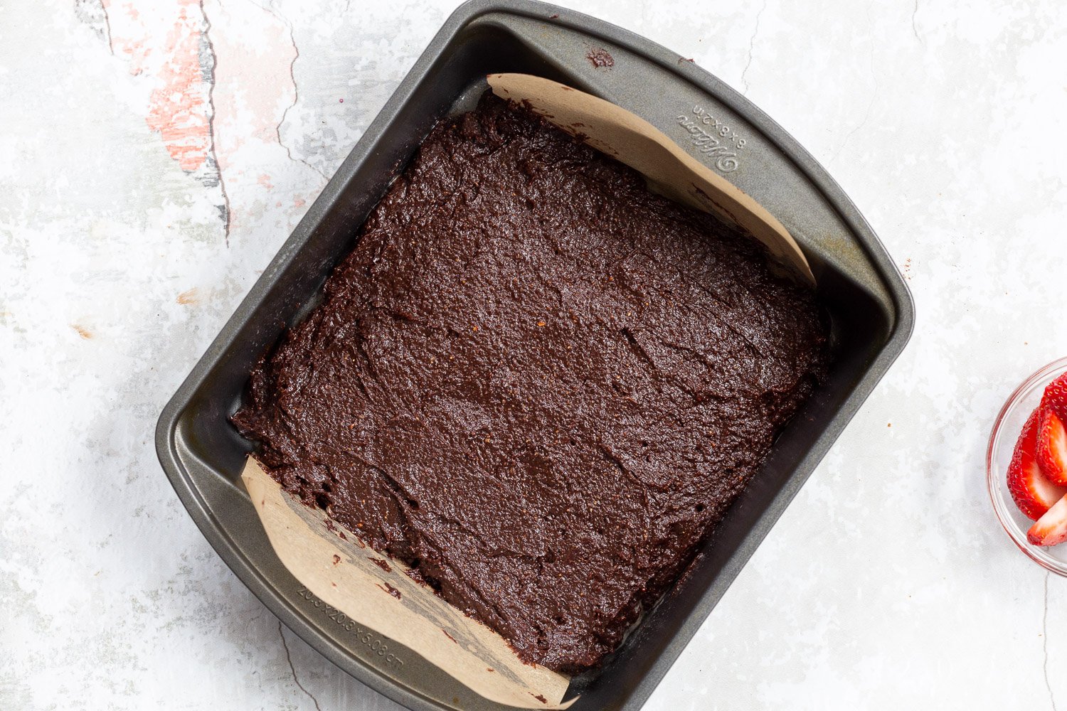 Batter for our Vegan Strawberry Brownies in a grey brownie pan