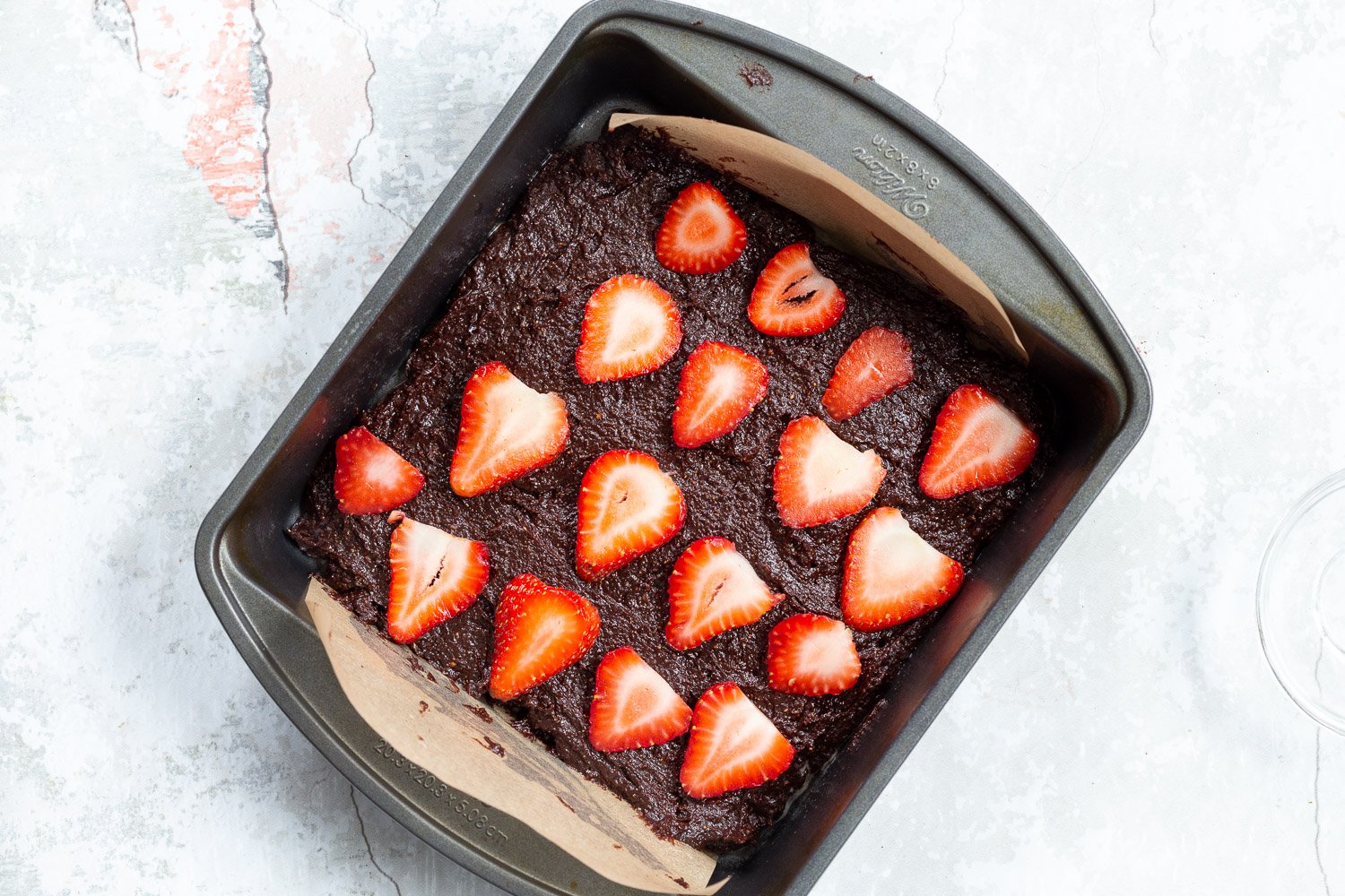 Batter for our Vegan Strawberry Brownies in a grey brownie pan