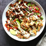 Chili Lime Roasted Veggies & Jackfruit drizzled with jalapeno cream sauce in a White Bowl