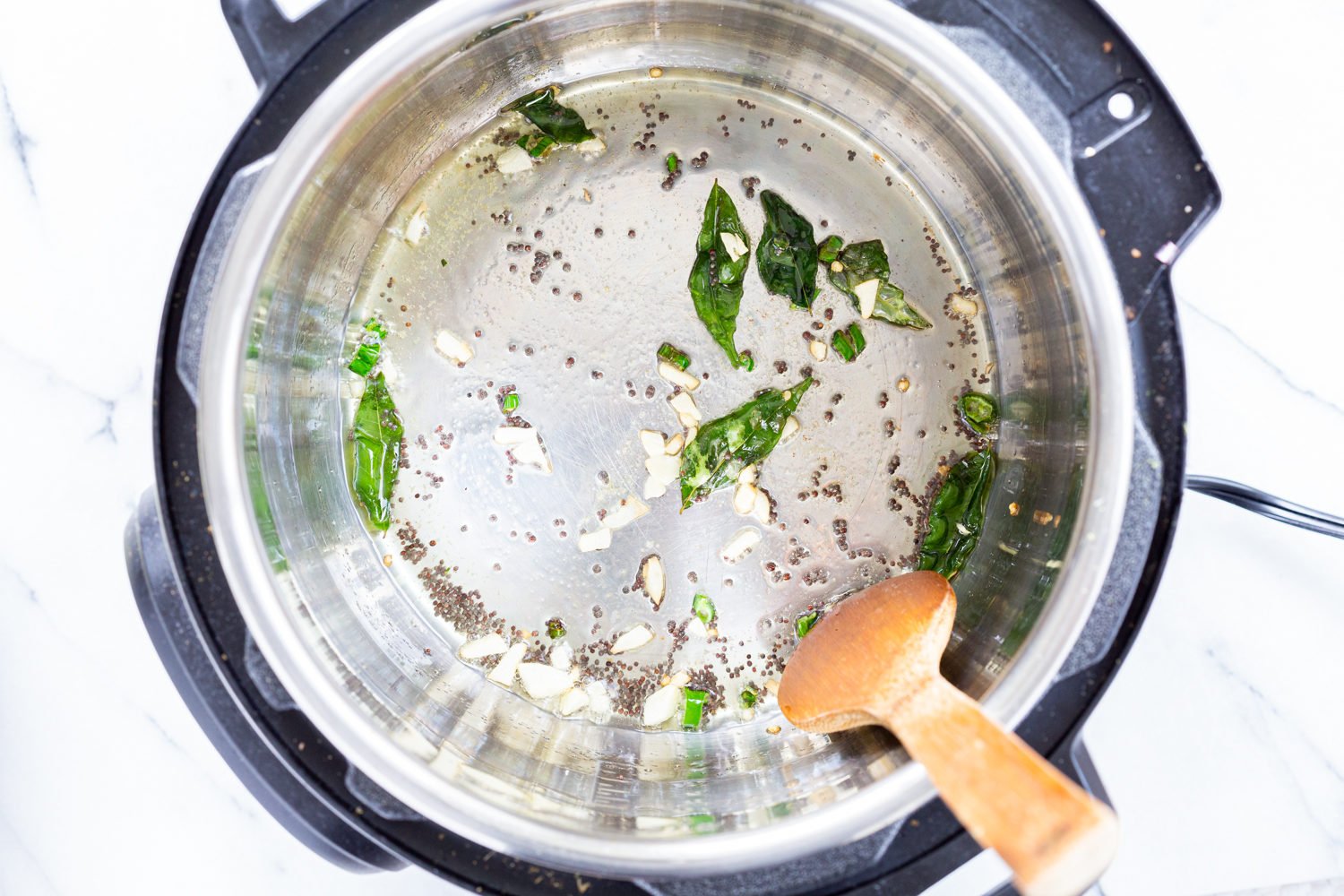 mustard seeds and curry leaves for our Indian Cabbage and Peas in Instant Pot