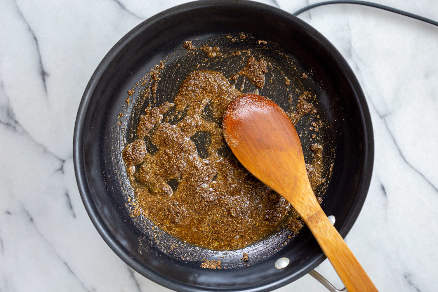 Spices roasted for our Vegan Keema Madras on a black skillet