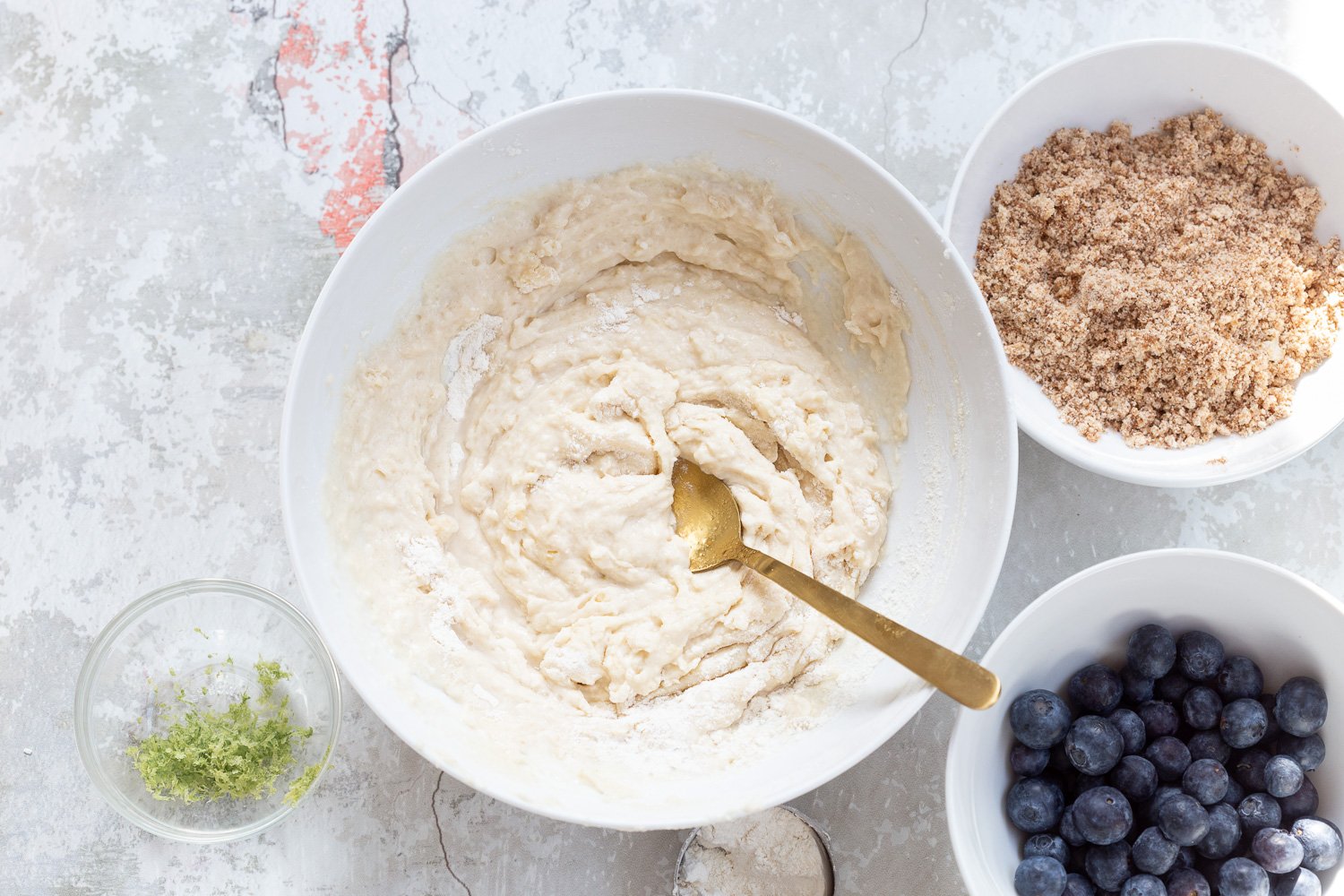 Batter for our Vegan Blueberry Muffins in a white bowl